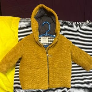 9-12 month, mustard colored coat with zipper. Two front pockets. Worn 2x.